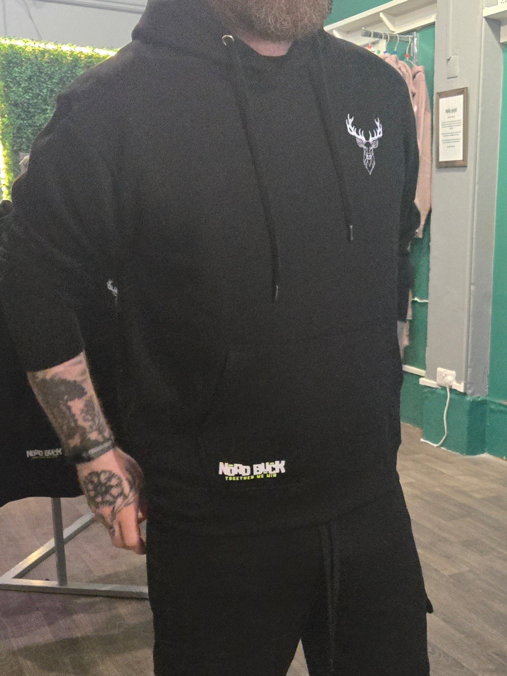 Man wearing Black Hoodie with Stag logo on