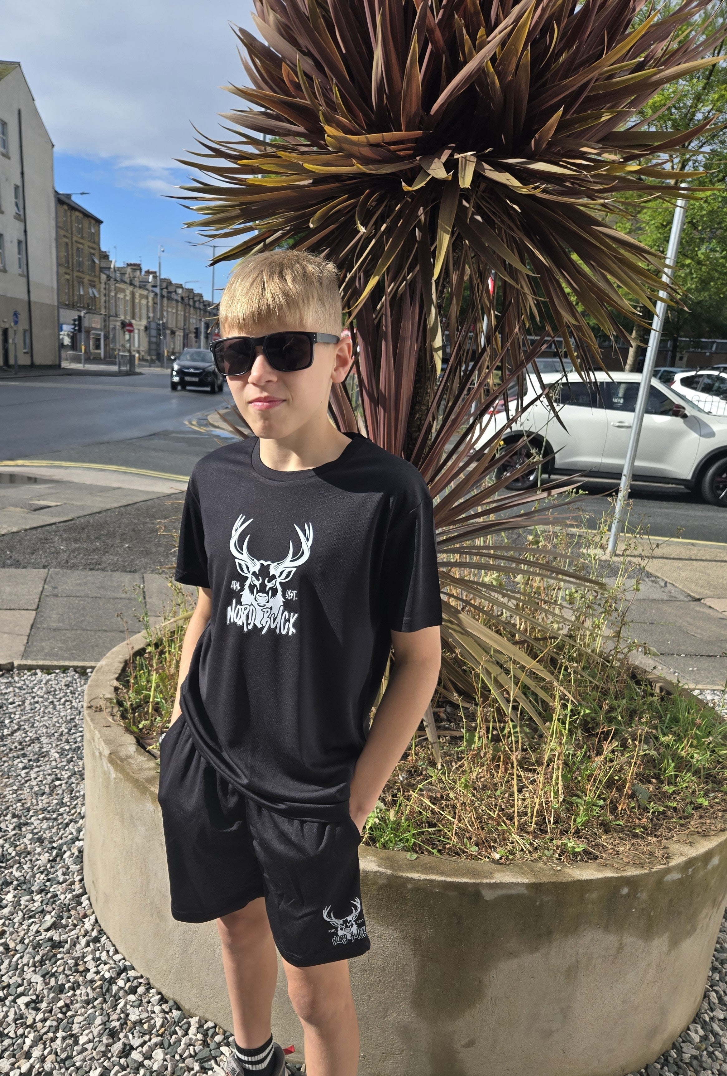 Teenage wearing black sports tshirt outside in the sun