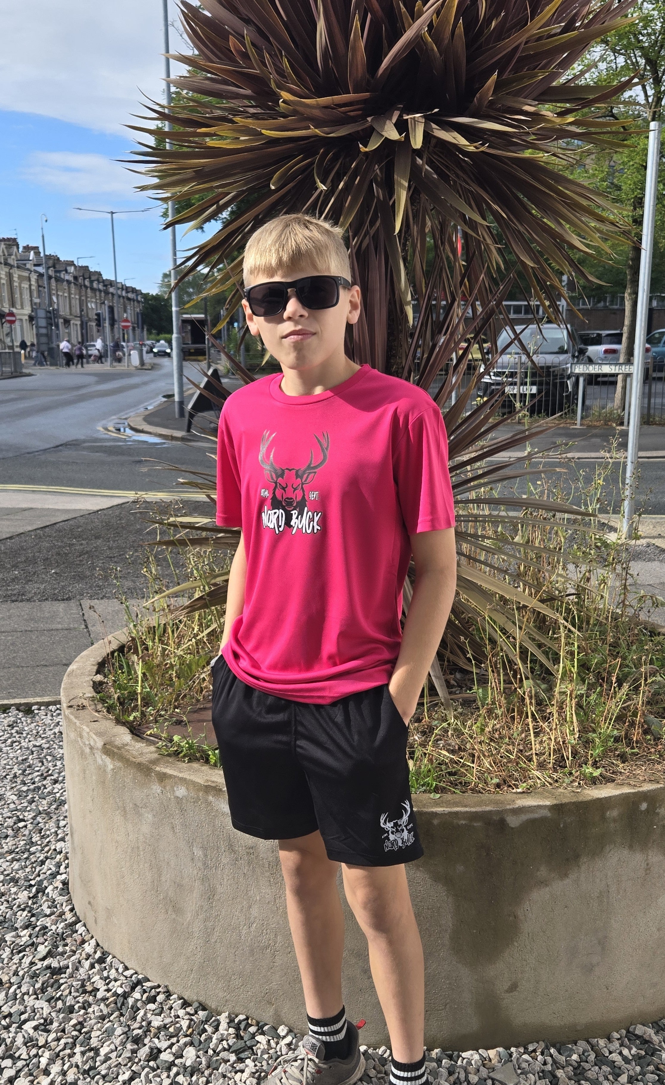 Teenage wearing Pink sports tshirt outside in the sun