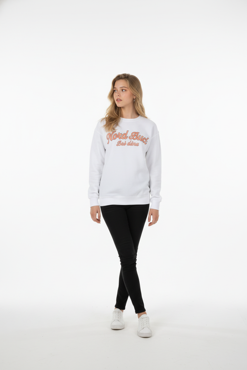 Woman wearing a white sweatshirt with text and black pants on a white background