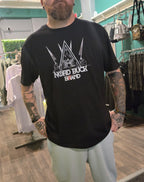 Person wearing a black t-shirt with 'Nord Buck Band' logo in a store setting