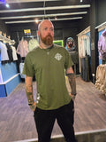 Person wearing a green tshirt with a logo in an indoor setting