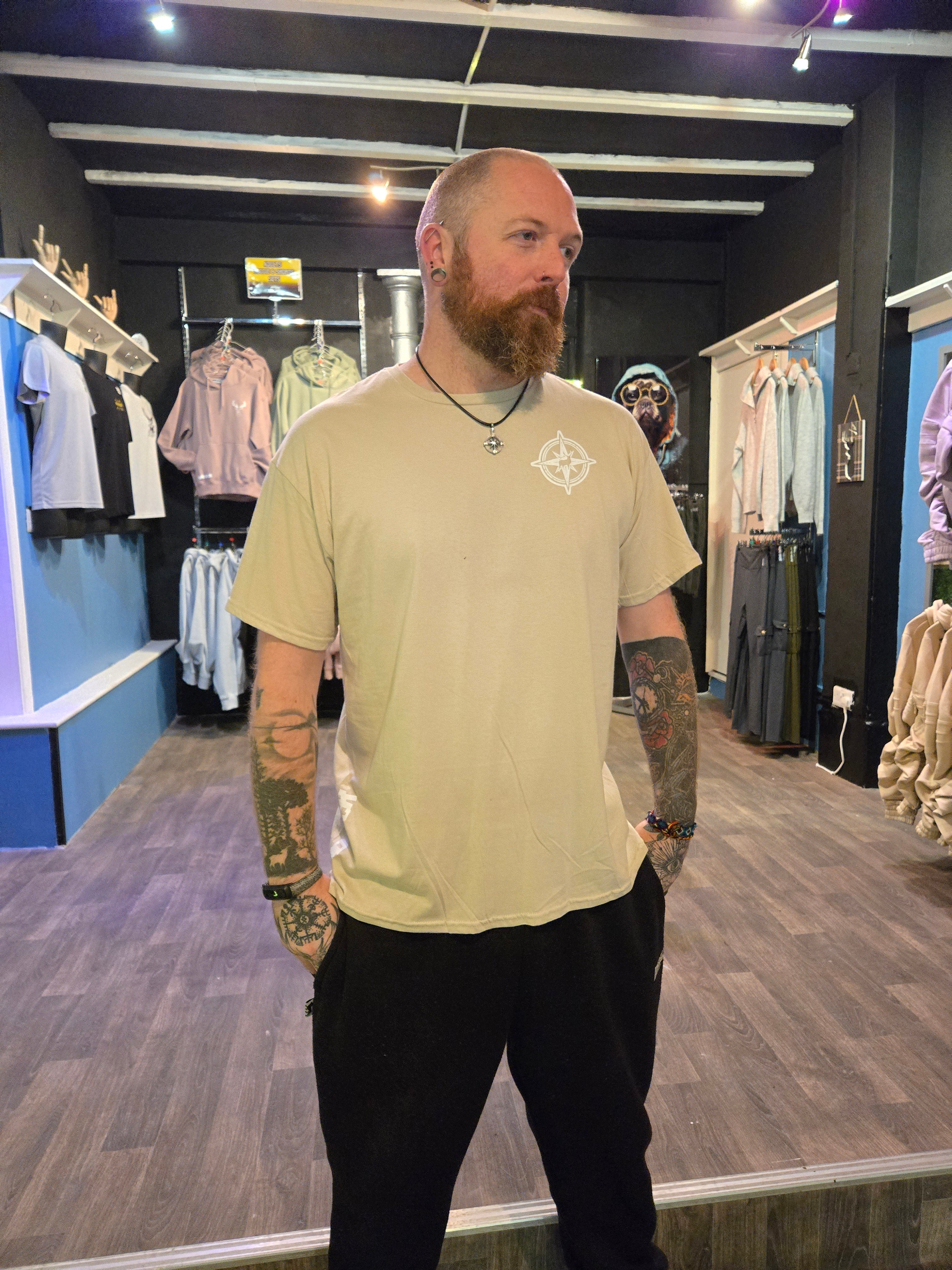 Man wearing a beige shirt with a logo in Nord Buck store.