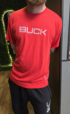 Person wearing a red 'Buck' branded shirt indoors.