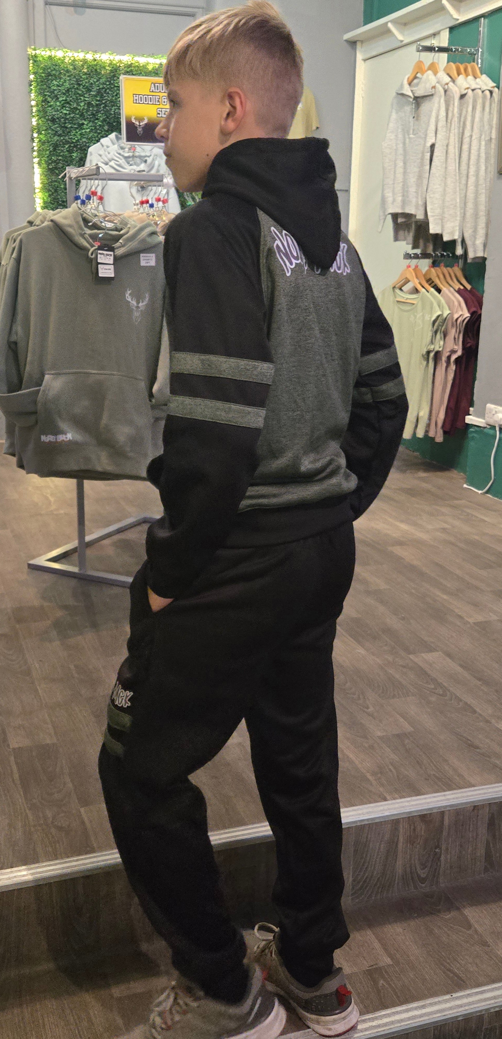 Teenager wearing green Nord Buck Tracksuit