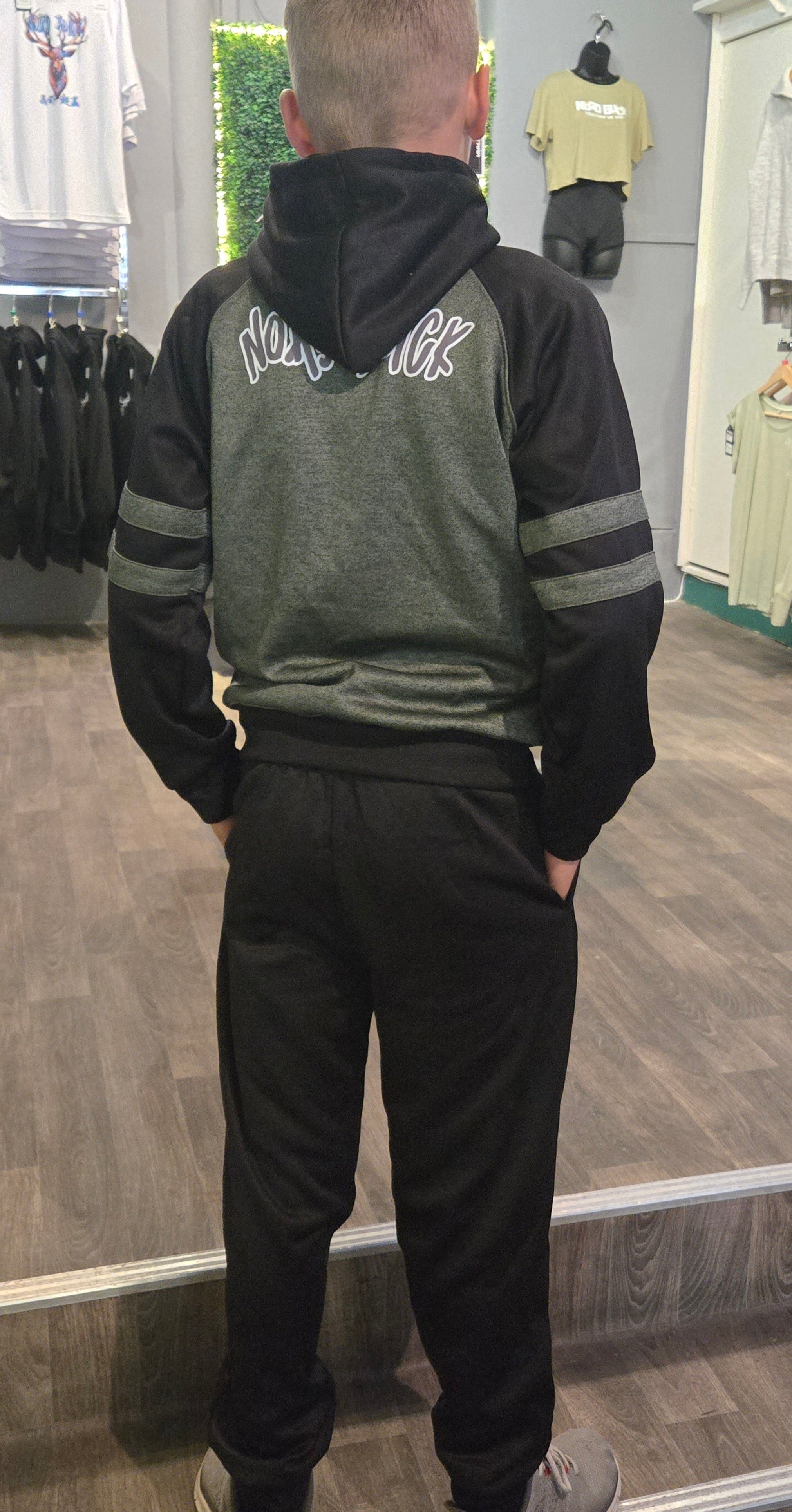 Teenager wearing green Nord Buck Tracksuit