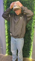 Older teenager wearing charcoal hoodie with beige hat