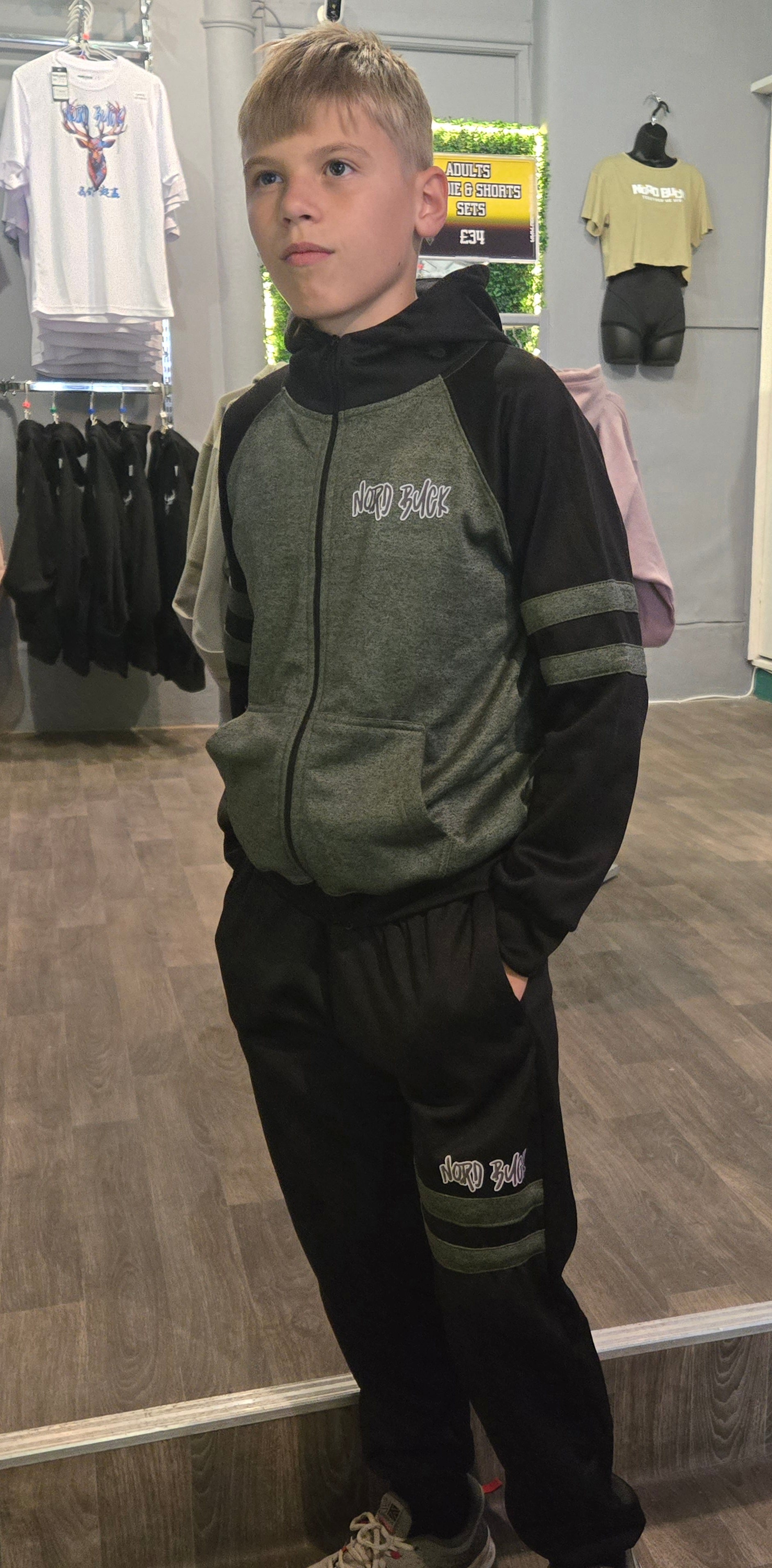 Teenager wearing green Nord Buck Tracksuit