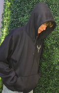 Adult wearing navy hoodie 