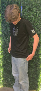 Man wearing black tshirt with silver stag logo on